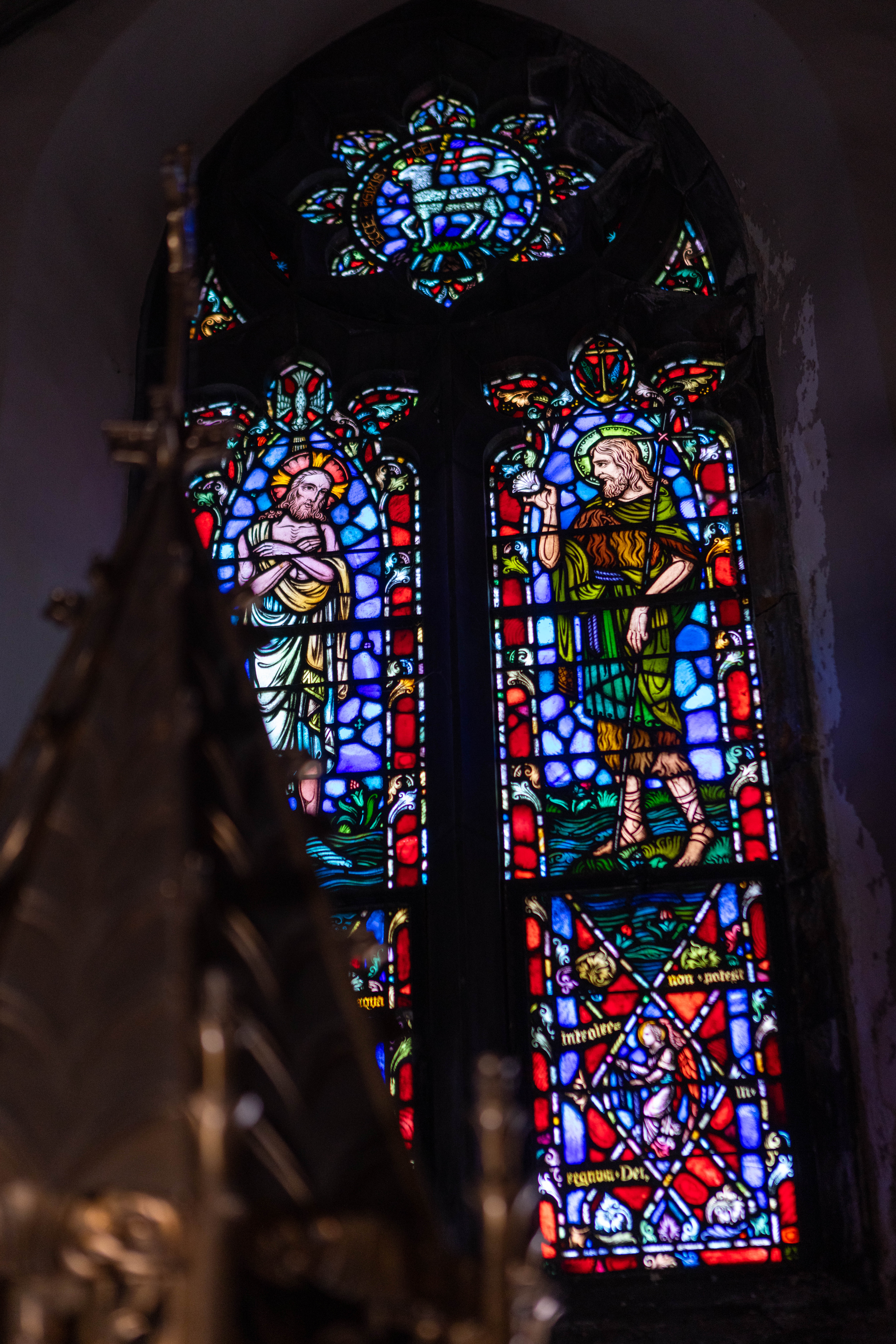 Window above the baptismal font at Holy Rosary Church